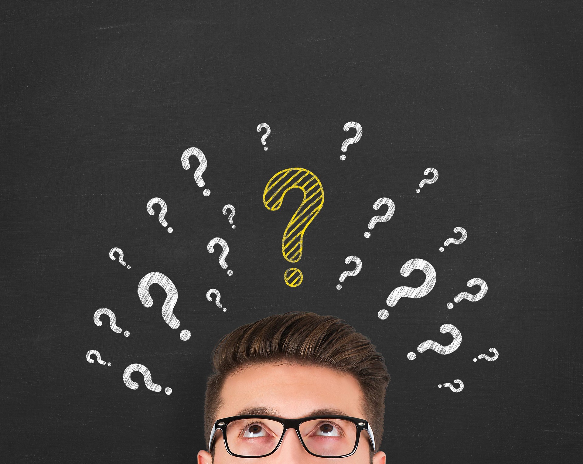 Man thinking on blackboard background